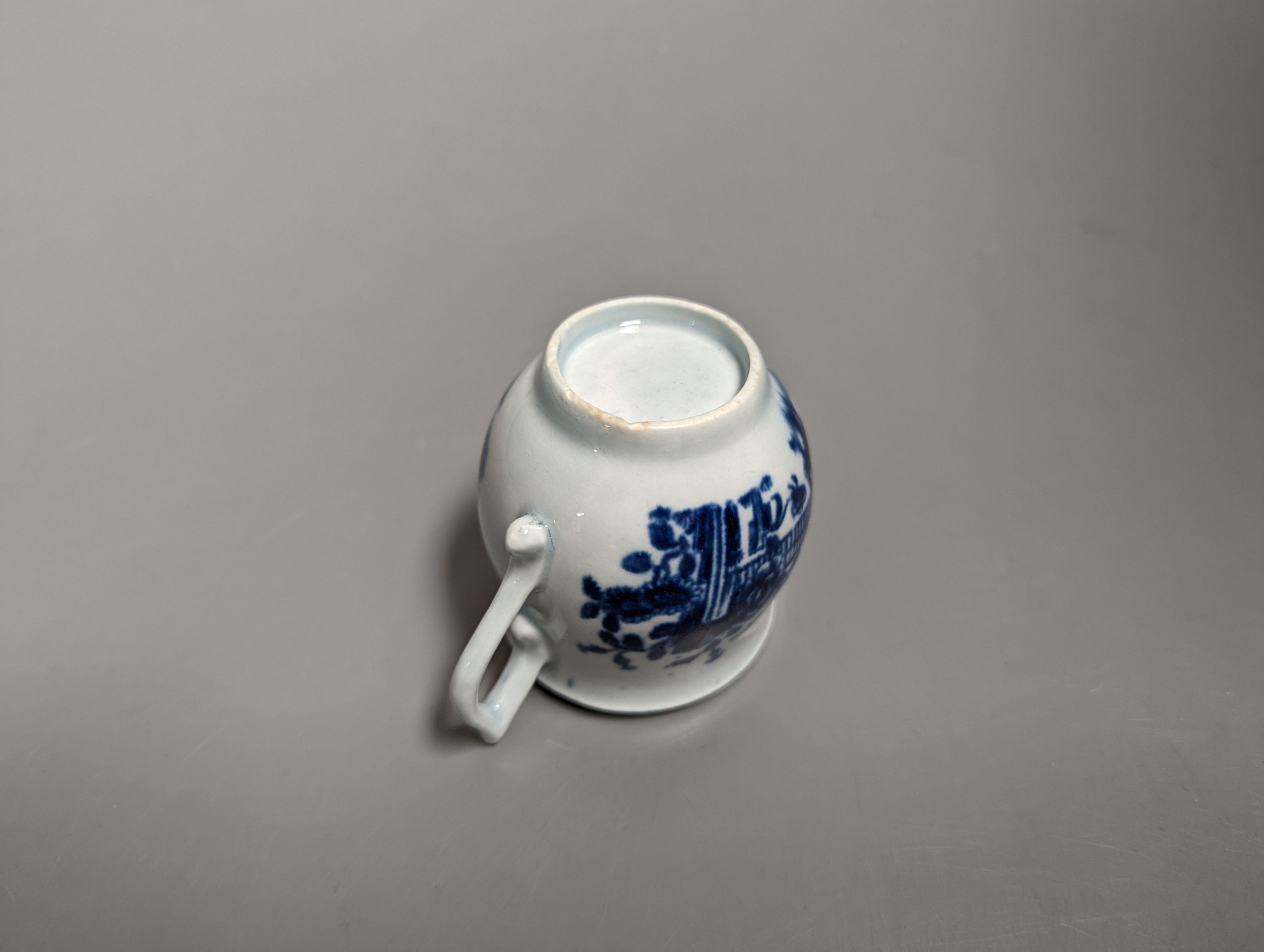 A rare Worcester wishbone handled bell shaped cup painted with the Plantation pattern c.1758, 6.5 cms high